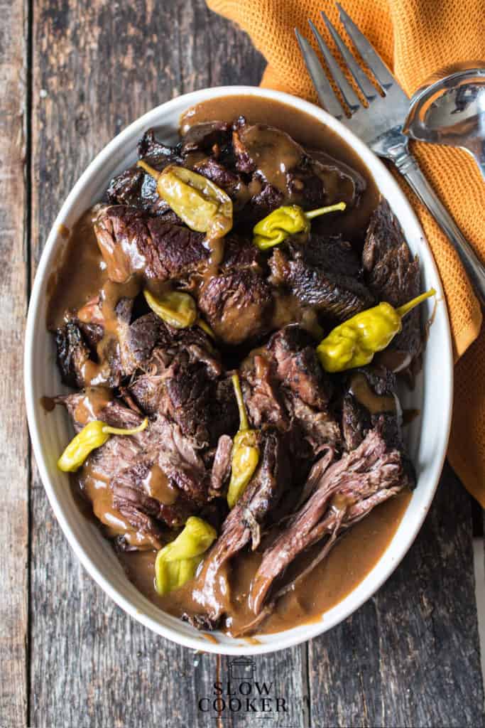 White oval bowl filled with Mississippi Pot Roast with sauces.