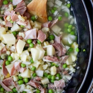 close shot of Slow Cooker Ham And Potato Soup in a black crock pot.