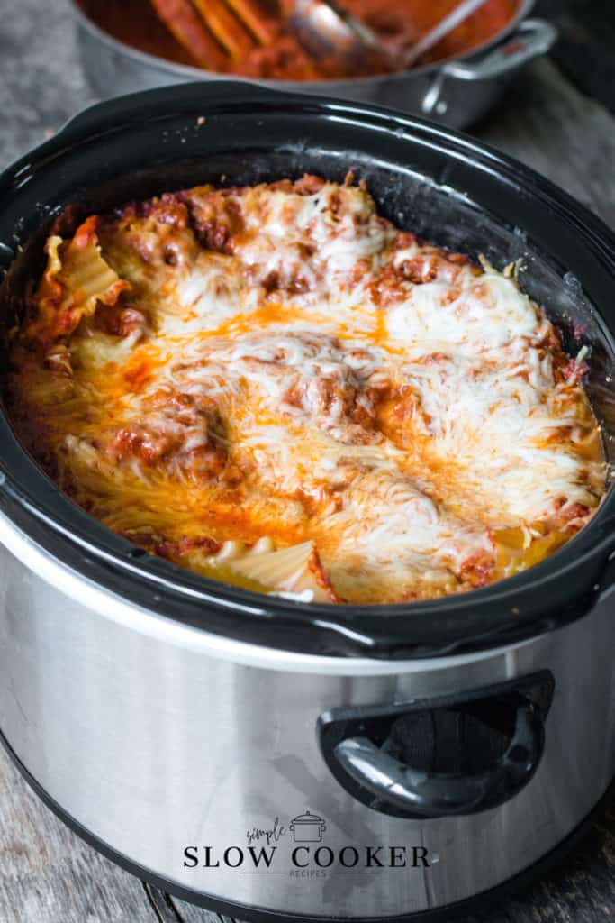 slow cooker full of lasagna, mozzerella cheese melted on the top.