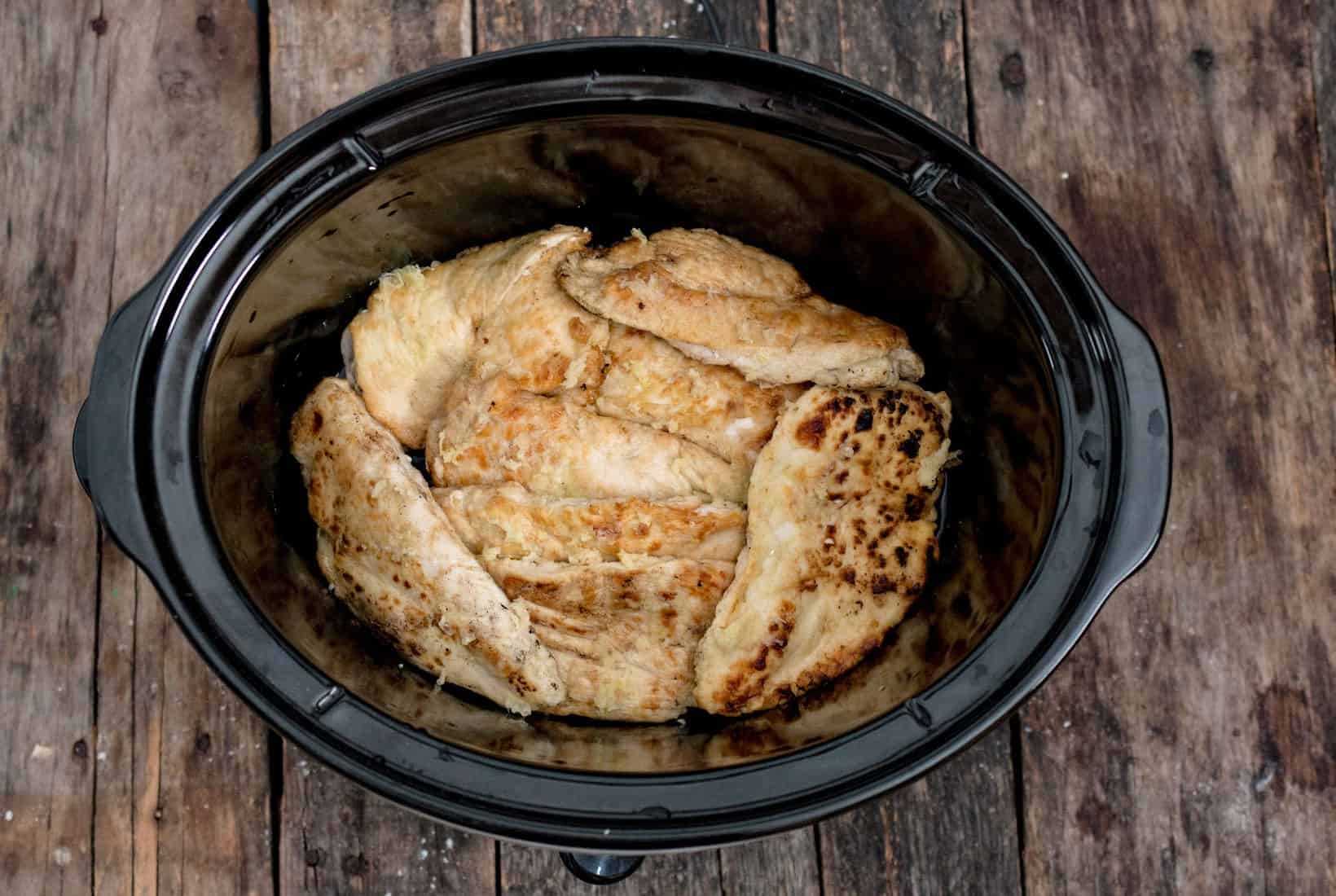 chicken breasts added to the base of the slow cooker.