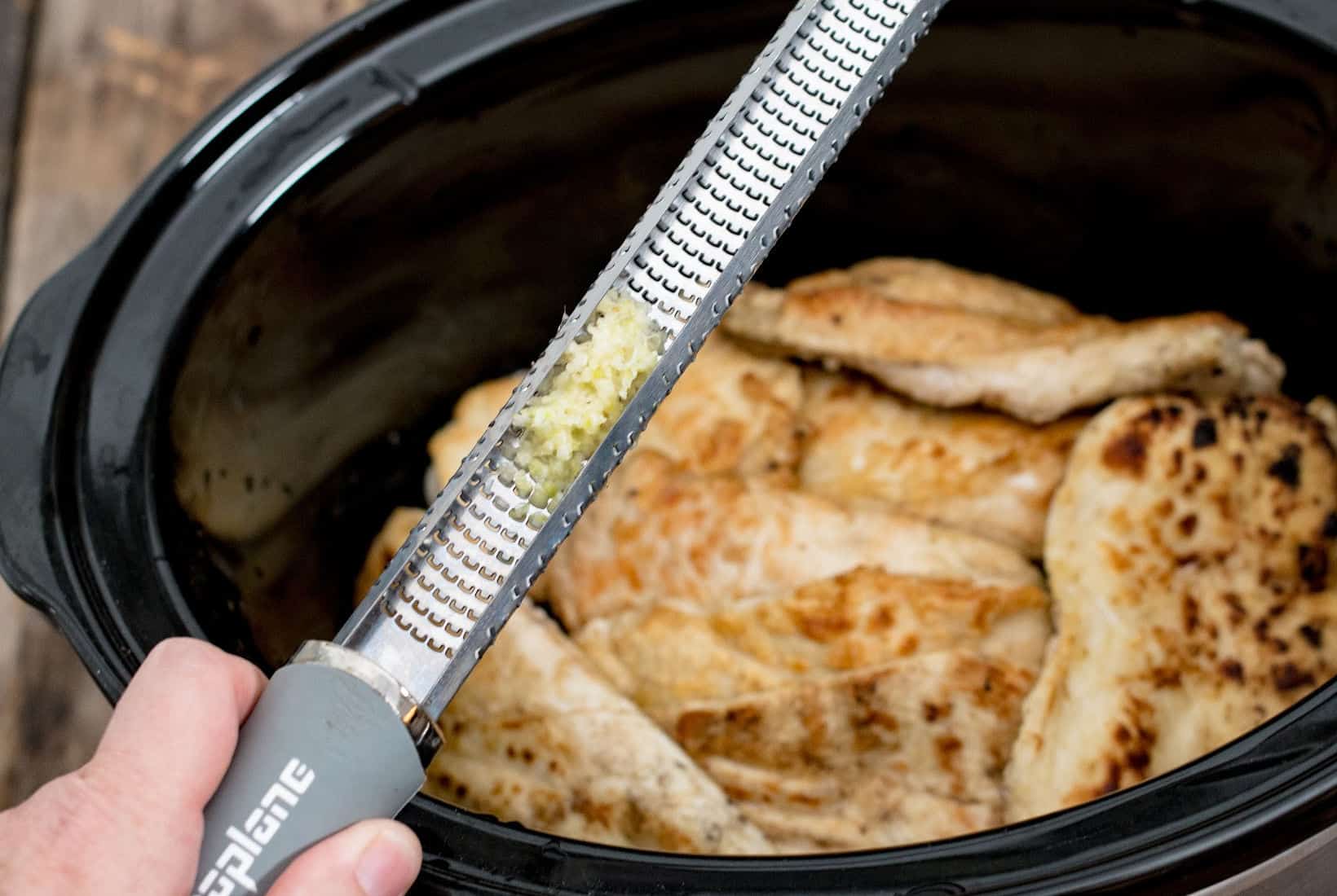 garlic in the back side of a microplane zester for Marry Me Chicken