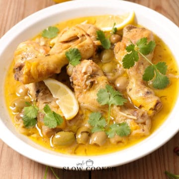 slow cooker lemon chicken legs in sauce in a white bowl.